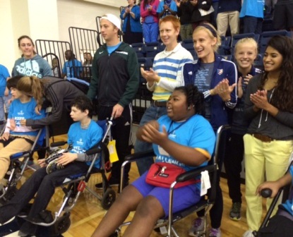Washington Center students (seated left to right) Katie Tollison, Jamie Rodriguez, and Ahnalliyah Wright, along with their student volunteers, celebrate during the opening ceremonies of Special Olympic Challenge Day on the Bob Jones University campus.