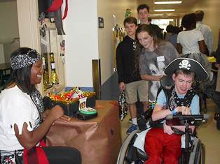 Washington Center student Jesse James is pictured Trick or Treating at teacher Nardia Lloyd’s pirate treat station with the assistance of Christ Church Episcopal School volunteer Micah Shutterly during the annual Washington Center Boo in the School event.