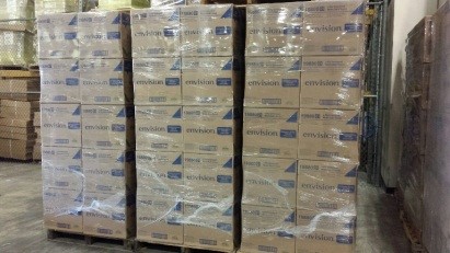 boxes stacked on pallets and shrinkwrapped