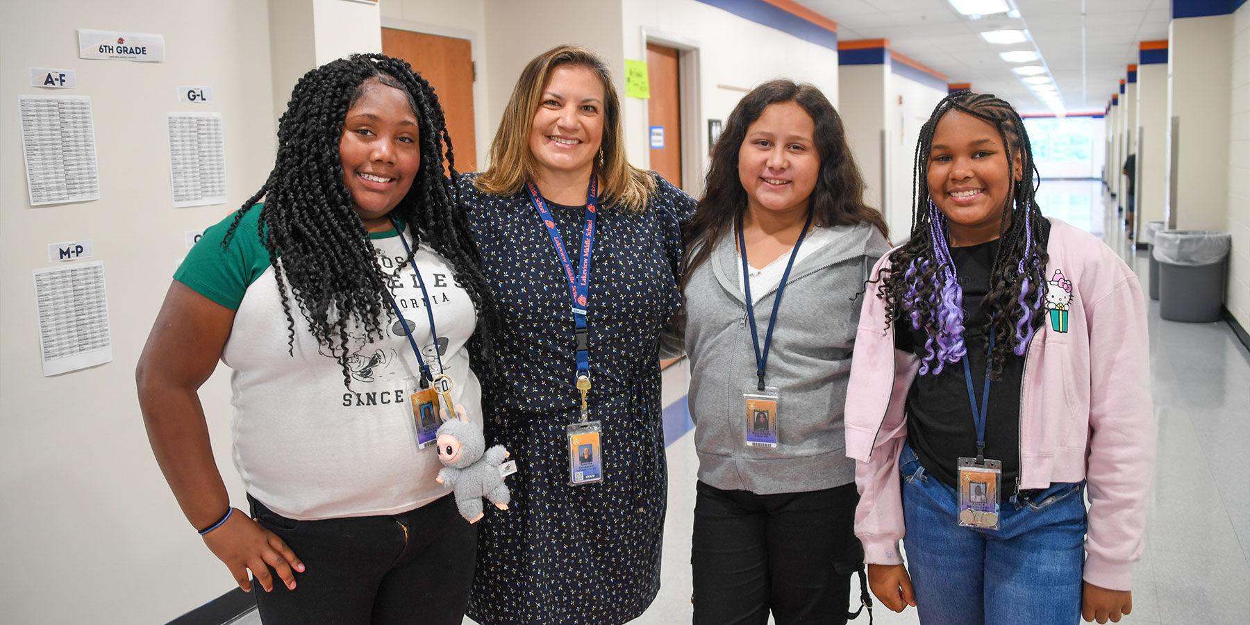 middle school students posing with an administrator