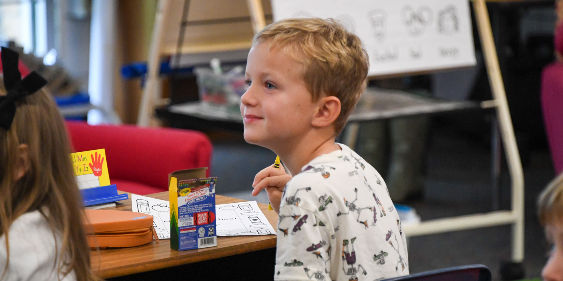 elementary student sitting at a desk