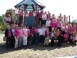 Large group of staff wearing pink in support of Breast Cancer Awareness Month