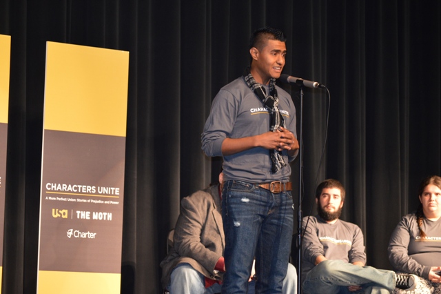 male student on a stage speaking