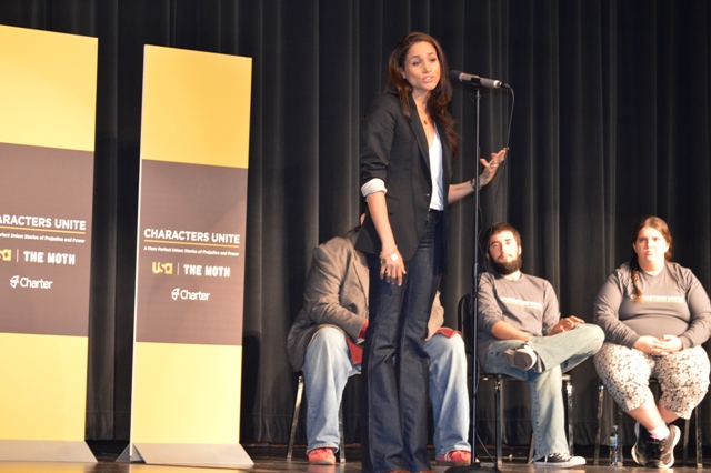 female student on a stage speaking