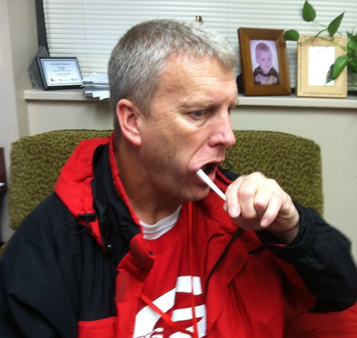 Principal JF Lucas gets DNA sample for National Geographic Genographic Project.