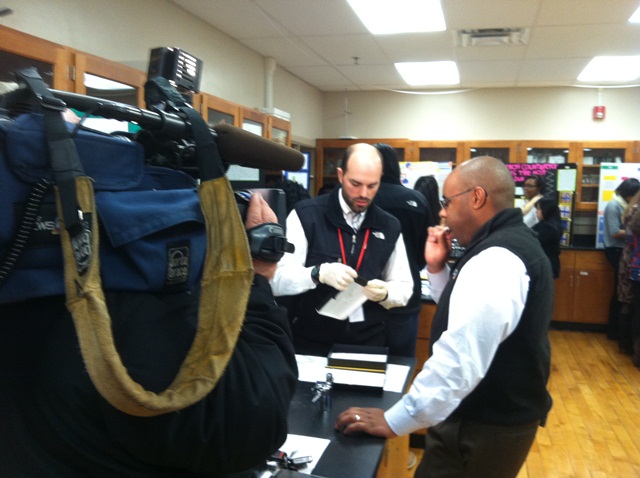 News 4 Reporter Nigel Robertson swabs his cheek for DNA as part of the National Geographic Genographic Project.