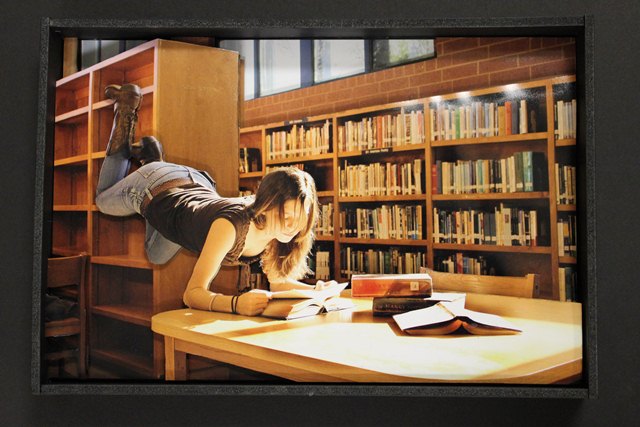 photo of levitating girl in library