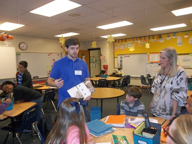 Clemson Student talking to students in a classroom