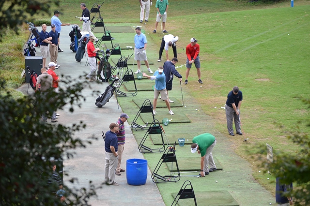 zoomed out photo of golfers teeing off
