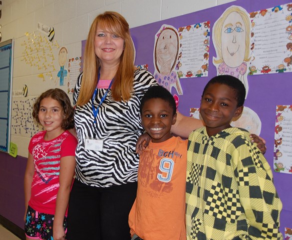 Sheila Motes with 3 elementary students