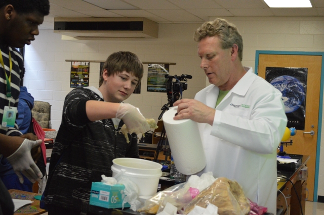 Scientist assisted by volunteer student