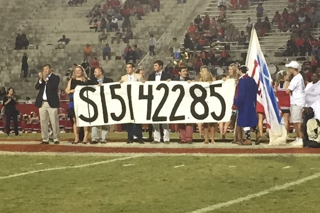 JL Mann Students holding a banner showing the amount of funds raised