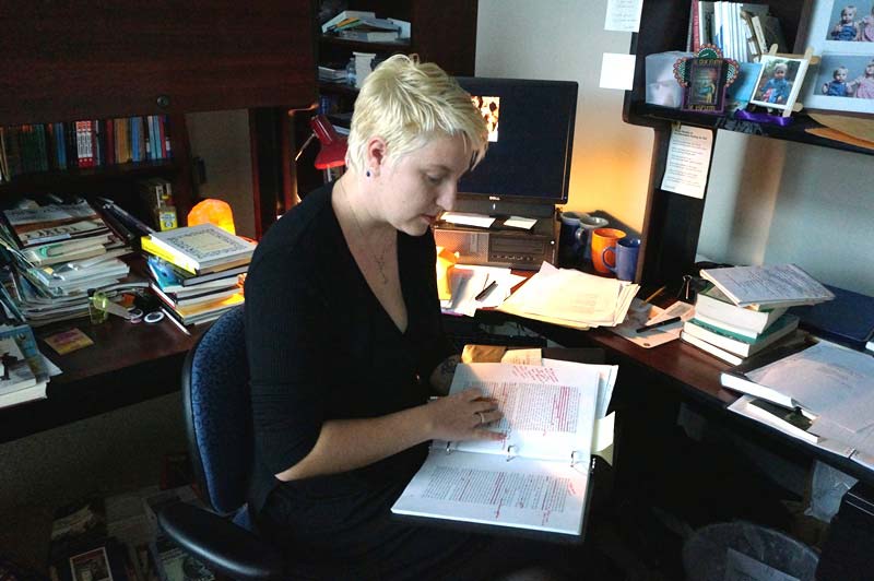 Sarah Blackman in office reading a book
