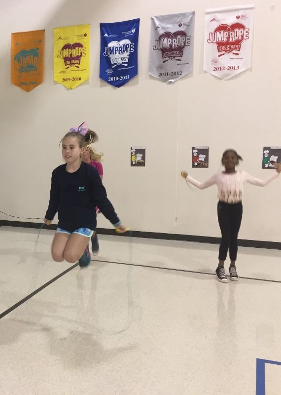 two girls in gym doing jump rope
