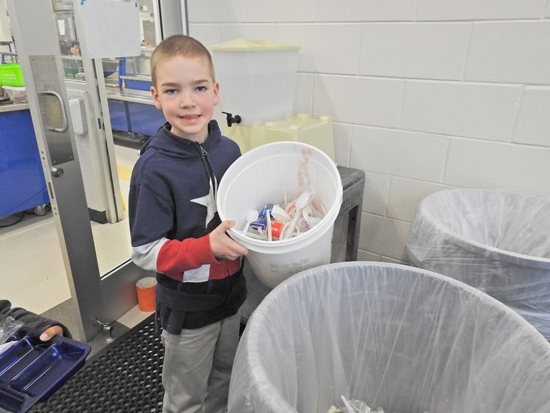 Cherrydale student gathering waste for composting
