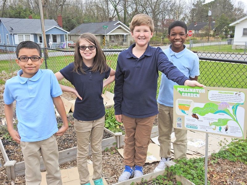 Four Cherrydale students in Pollinator Garden
