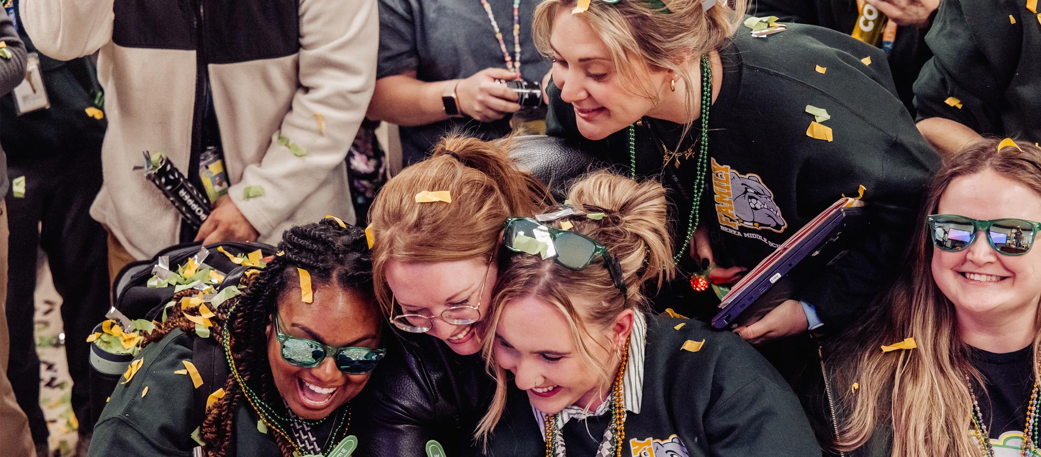 4 teachers looking excitedly at something