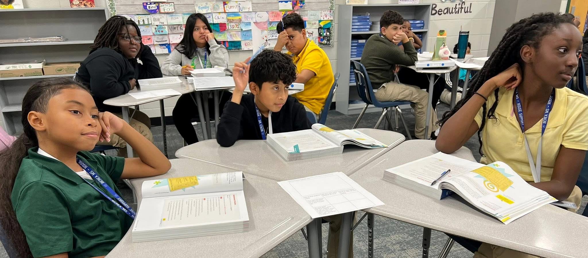 students sitting at table in classroom