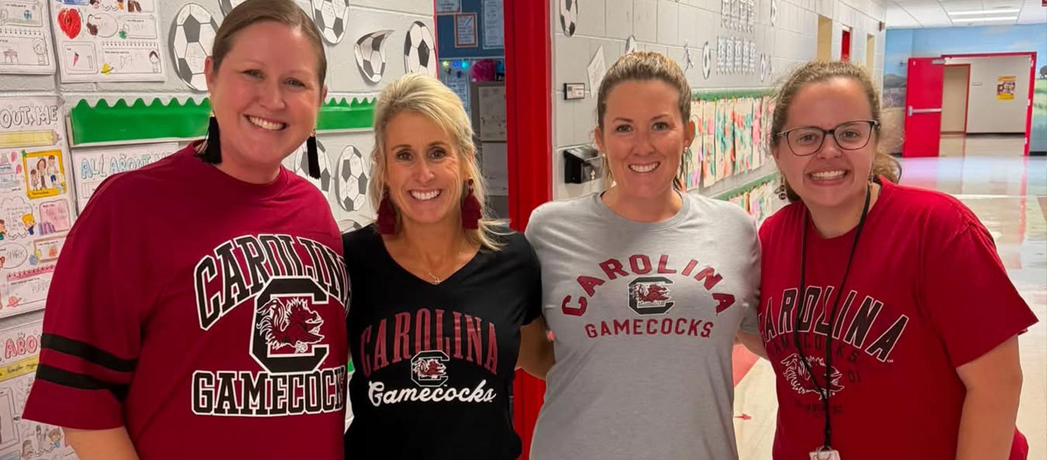 4 staff members with Gamecock attire