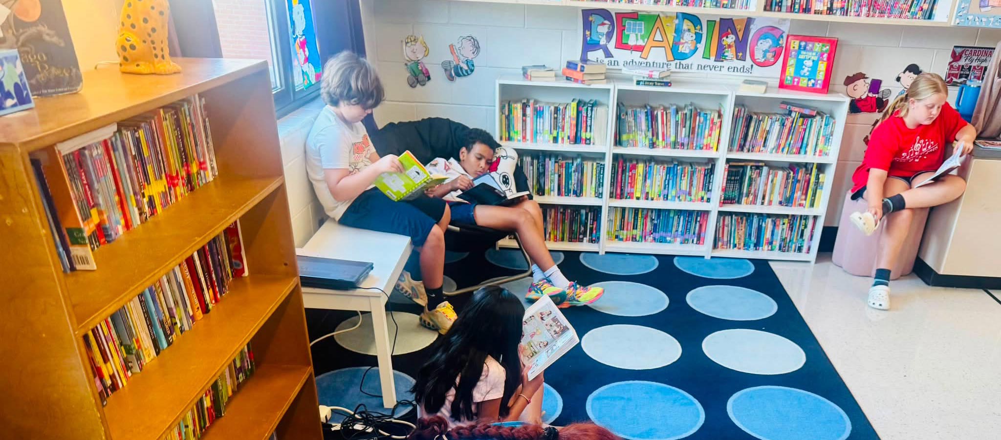 3 students reading in the library