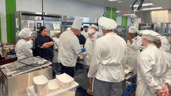 Advanced Enoree Culinary Arts student preparing and plating a professional dish