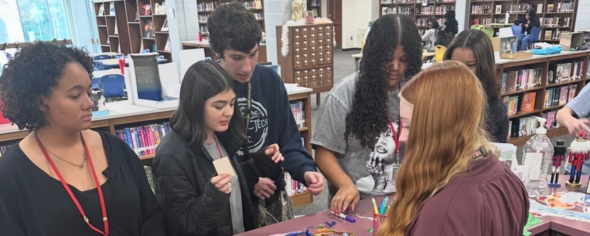 students working at the front desk of the library