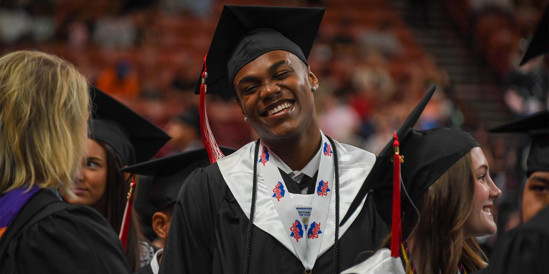 Smiling senior male in Graduation regalia