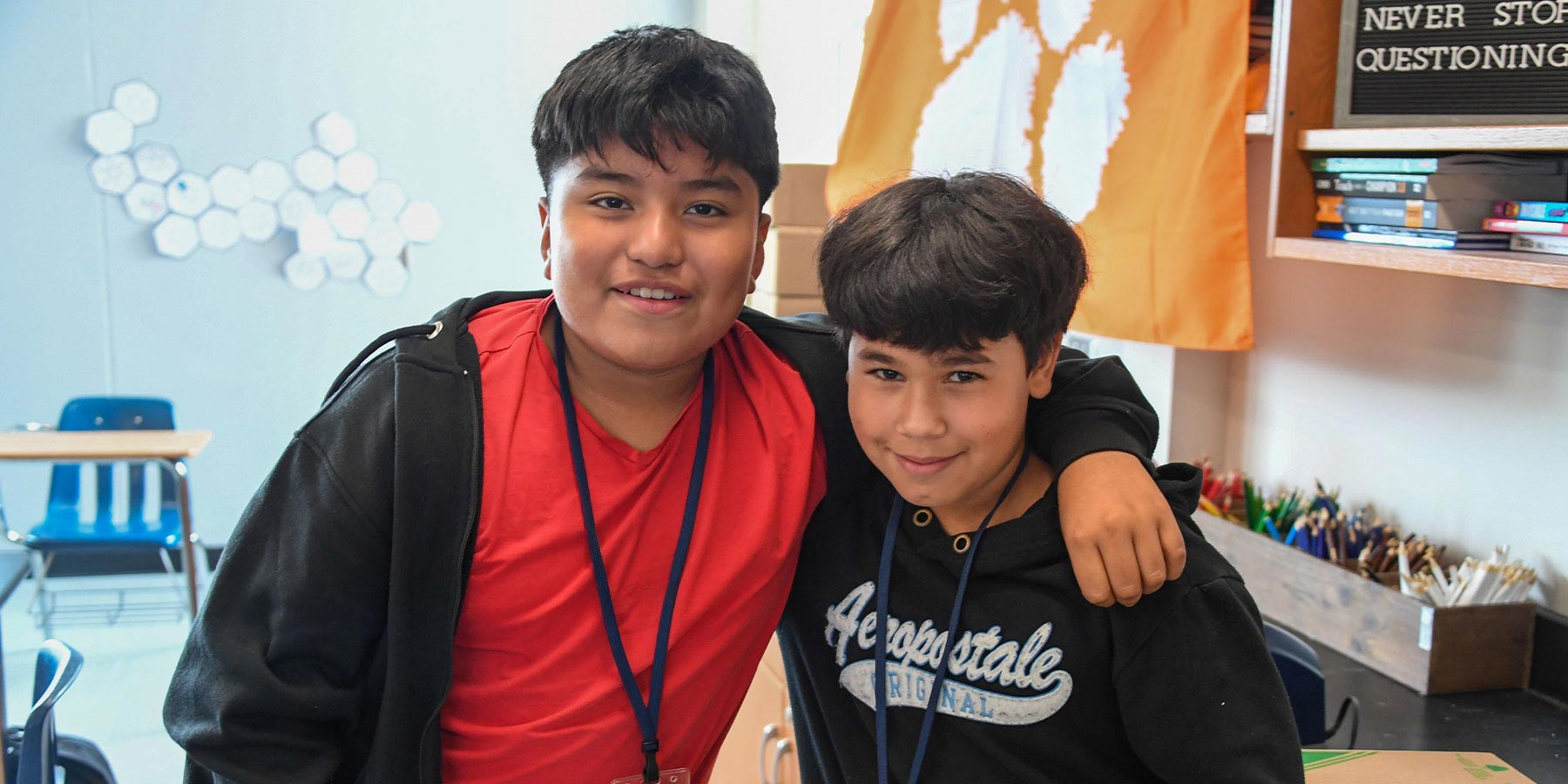 two middle school boys posing for camera