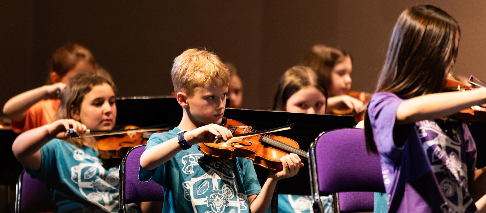 group of students playing violins
