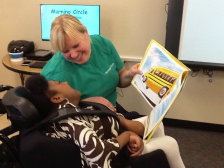 Washington Center teacher Amy Garbe reads The Energy Book for Kids to student Taneda Brooks participating in the school-wide positivity theme. 