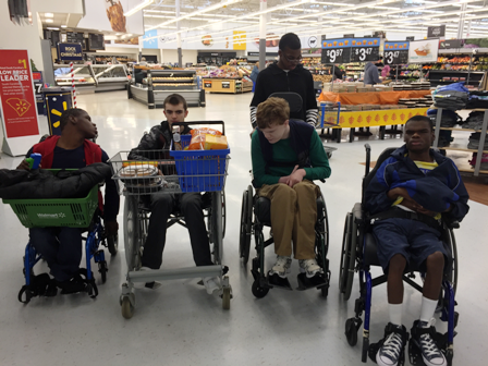 Students in Mrs. Virginia Cook’s Washington Center class carry baskets for others practicing courtesy and kindness while shopping for supplies at the local Wal-Mart.